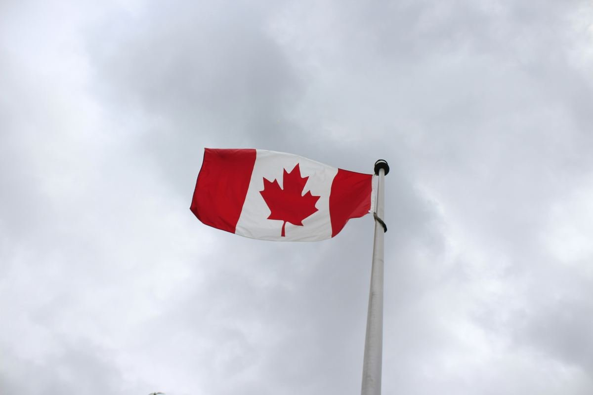 Happy family in Canada with Canadian flag